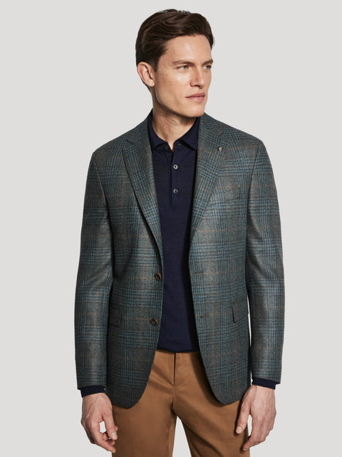 Men's olive and brown plaid blazer with notched lapels and button front, worn with navy polo shirt and tan trousers.