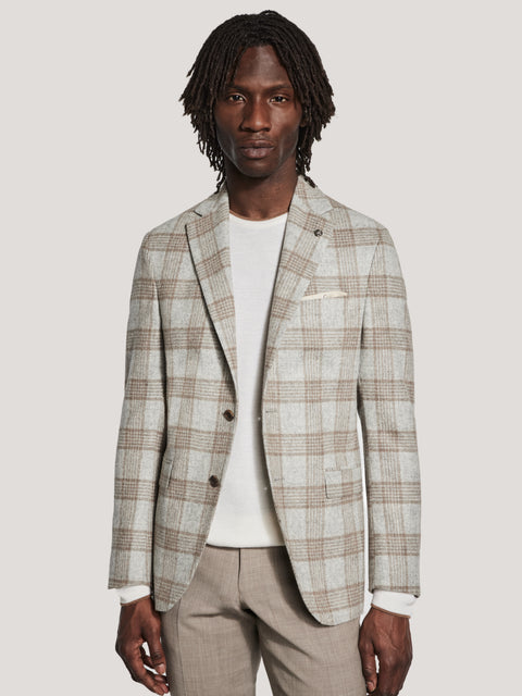 Light grey and camel plaid blazer with notch lapels and brown buttons worn over white t-shirt.