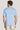 Man wearing light blue crew neck t-shirt with short sleeves, shown from back view.