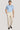 Man wearing light blue crew neck t-shirt and cream pleated trousers with brown leather shoes.