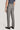 Grey plain front trousers with straight leg fit, shown from back view on male model wearing navy shirt and black loafers.