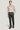 Man wearing pine green stretch chino pants with beige crew neck sweater and brown lace-up boots.