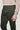 Pine green chino pants with a flat front waistband and metal button closure, shown on model wearing beige sweater.