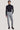 Light blue corduroy tailored trousers with side tabs, styled with a black turtleneck.