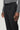 Charcoal wool tailored trousers with black waistband and side tab buckle detail, worn with gray sweater.