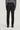 Charcoal wool tailored trousers with side tabs and button details, shown from back view on model wearing gray sweater.