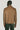 Tan Harrington jacket with collar, shown from back on model wearing dark green pants.