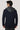 Navy blazer with detachable gray hooded bib, shown from back view on male model.
