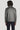 Mid grey harrington jacket with collar, shown from back on model wearing dark trousers.