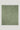 Sage green twill throw with fringe trim on all edges and a small woven label in the corner.