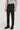 Man wearing black solid stretch suit pants with gray t-shirt and black leather shoes.