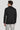 Black double breasted textured knit blazer with notch collar and button cuffs, shown on model from back view.