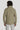Sage green field jacket with long sleeves and stand collar, shown from back view on model wearing light pants.