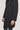 Charcoal wool coat with double-breasted front, four metal buttons, and notch lapels worn over dark trousers.
