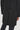Charcoal wool coat with double-breasted front, button closures, and notch lapels worn over dark trousers.