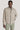 Beige harrington jacket with full zip front, collar, and hand pockets worn over gray shirt and sage green pants.