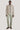Beige Harrington jacket with full zip and collar worn over sage green pants and black sneakers.