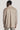 Sand-colored linen shirt jacket with long sleeves and collar, shown from back view on model.