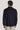 Dark navy shirt jacket with textured weave fabric, long sleeves, and spread collar, shown from back view.