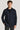 Navy wool shirt jacket with button front, collar, and chest pockets worn over a dark shirt.