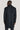 Navy twill topcoat with textured weave, shown from back view on model wearing dark trousers.