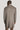 Taupe twill topcoat with cream-colored collar and removable bib, shown on model from back view.