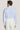 Man wearing light blue long-sleeve dress shirt with collar, shown from back view.