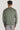 Sage green cardigan with ribbed cuffs and hem, shown from back on male model wearing light gray pants.