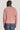 Man wearing pink crew neck sweater and blue jeans, shown from back.