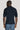 Dark navy textured polo shirt with short sleeves and collar, shown from back view on model.