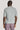 Grey textured polo shirt with quilted pattern, shown from back view on model wearing mauve trousers.