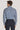 Navy floral print long-sleeve button-up shirt worn with dark trousers, shown from back view.