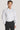 White dress shirt with long sleeves, button front closure, and pointed collar worn with black dress pants.