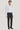 White long-sleeve dress shirt with button front and spread collar, worn with black trousers and black dress shoes.