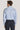 Light blue striped dress shirt with long sleeves and button cuffs, shown from back view on model.