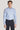 Light blue dress shirt with micro geoprint pattern and white button front, worn with dark trousers.