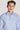 Man wearing light blue dress shirt with micro geoprint pattern and button front closure.