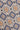 Blue tie with geometric pattern featuring tan ovals and diamond shapes with navy accents.