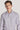 Man wearing lavender dress shirt with small geometric micro print pattern and white button front.