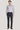 Man wearing lavender micro-pattern dress shirt with white buttons and navy trousers.