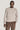 Beige crewneck sweatshirt with ribbed knit texture worn with brown corduroy pants.