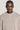 Beige crewneck sweatshirt with ribbed texture worn by a man against a neutral background.