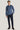 Man wearing blue crewneck sweatshirt with ribbed cuffs and navy pants.