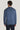Blue crewneck sweatshirt with ribbed knit texture, shown from back on model wearing dark pants.