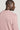 Pink crewneck sweatshirt with ribbed texture shown from back view on model.