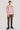 Pink crewneck sweatshirt with ribbed cuffs and hem, worn with brown corduroy pants and black boots.