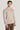 Sand-colored crewneck sweatshirt with ribbed knit trim worn by a man against a neutral background.