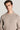 Beige crewneck sweatshirt with ribbed texture worn by man against white background.