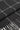 Black and white houndstooth patterned scarf with fringe trim folded to show texture and weave detail.