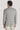 Light grey and tan plaid blazer with long sleeves, shown from back view on model wearing cream pants.